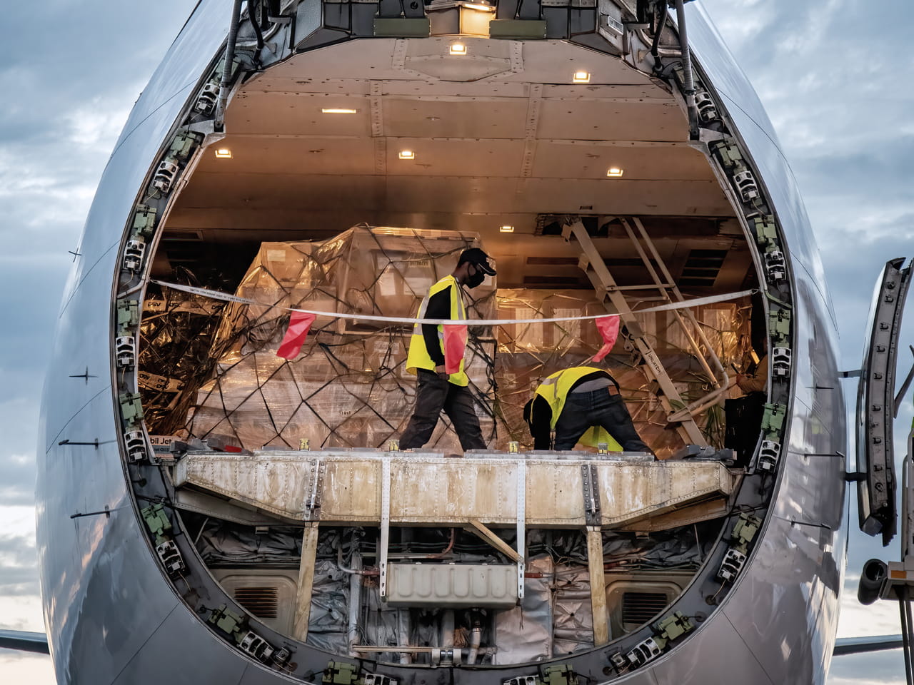 A DSV cargo plane is being loaded through its open front hatch with DSV man staff inside.